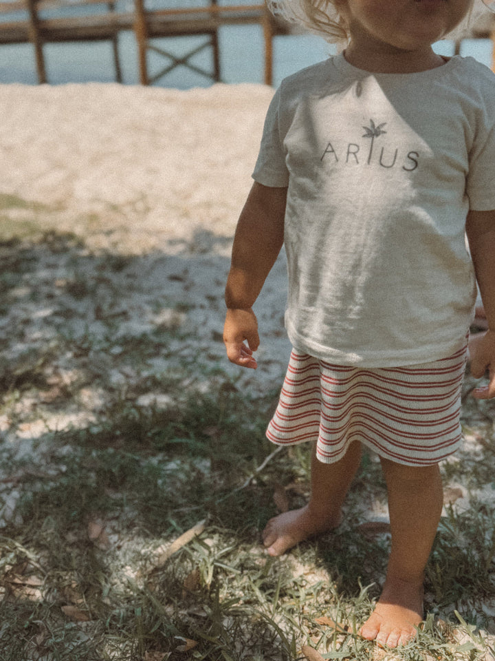 Natural coloured organic cotton baby t-shirt on beach in Australia