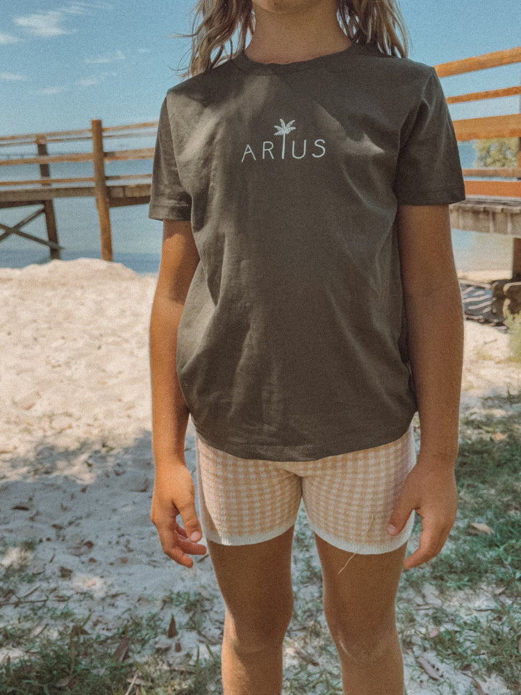 Green or Khaki coloured organic cotton t-shirt on kid at beach in Australia