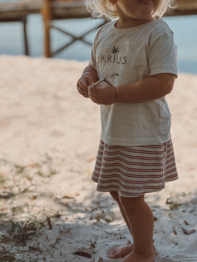 Organic Cotton Baby T-Shirt in natural colour on beach in Australia