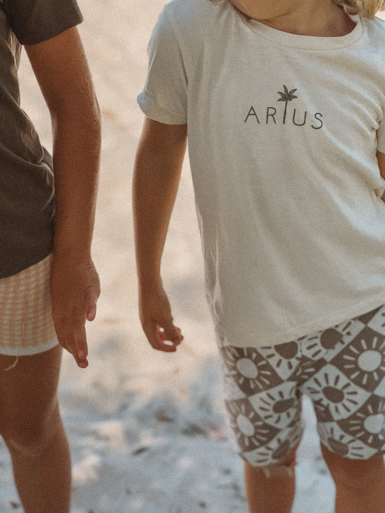 Natural coloured organic cotton kids t-shirt on Australian beach